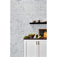 Thumbnail image of Marble mosic wall tile fill wall behind floating shelf and counter all with clean lines.